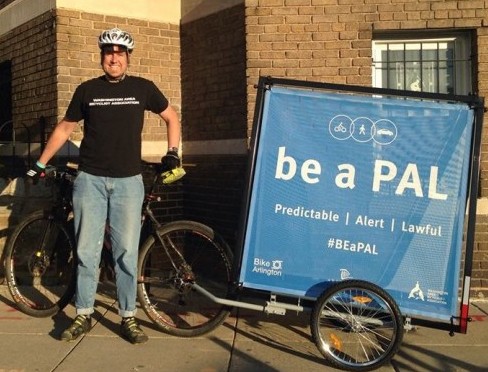 Sign says "Be a Pal" on bike Trailer