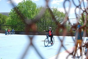 A bicycist practices signalling a turn.