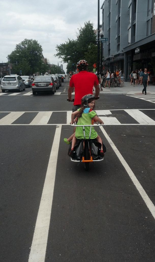 Jon and his two daughters riding on 14th Street NW