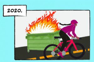 A woman with a long braid biking up a hill. On the side of the road, a dumpster is engulfed in flames. The caption reads “2020.”